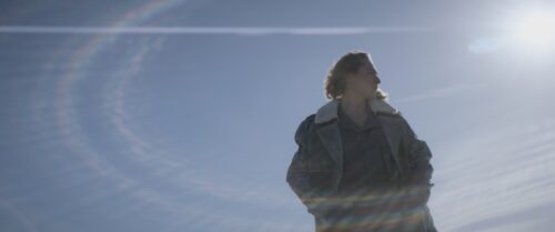Man in jeans coat with sun in the background. His hands are in the pockets of his jacket, his forehead lies in wrinkles.
Short on LOMO Square Fronts.