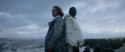 Two men standing back to back with a shoreline in the background (sad mood). 
Short on LOMO Square Fronts.