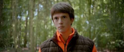 Close up of a young man staring into the camera. Blurry background due to the open aperture of the Zeiss Standard Speed