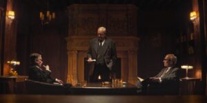 Wide angle low key shot of three men are talking in an old wooden furnished conference room.