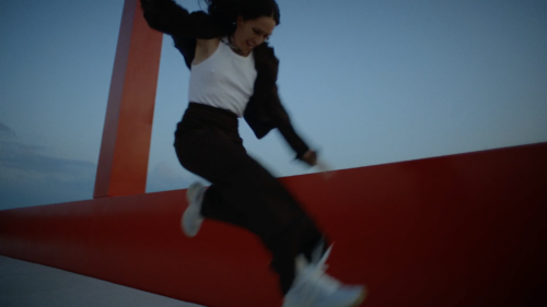 Woman running across a bridge.
