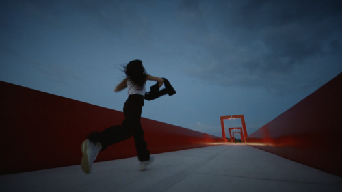 Woman running across a bridge.