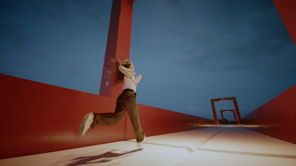 Woman running across a bridge.