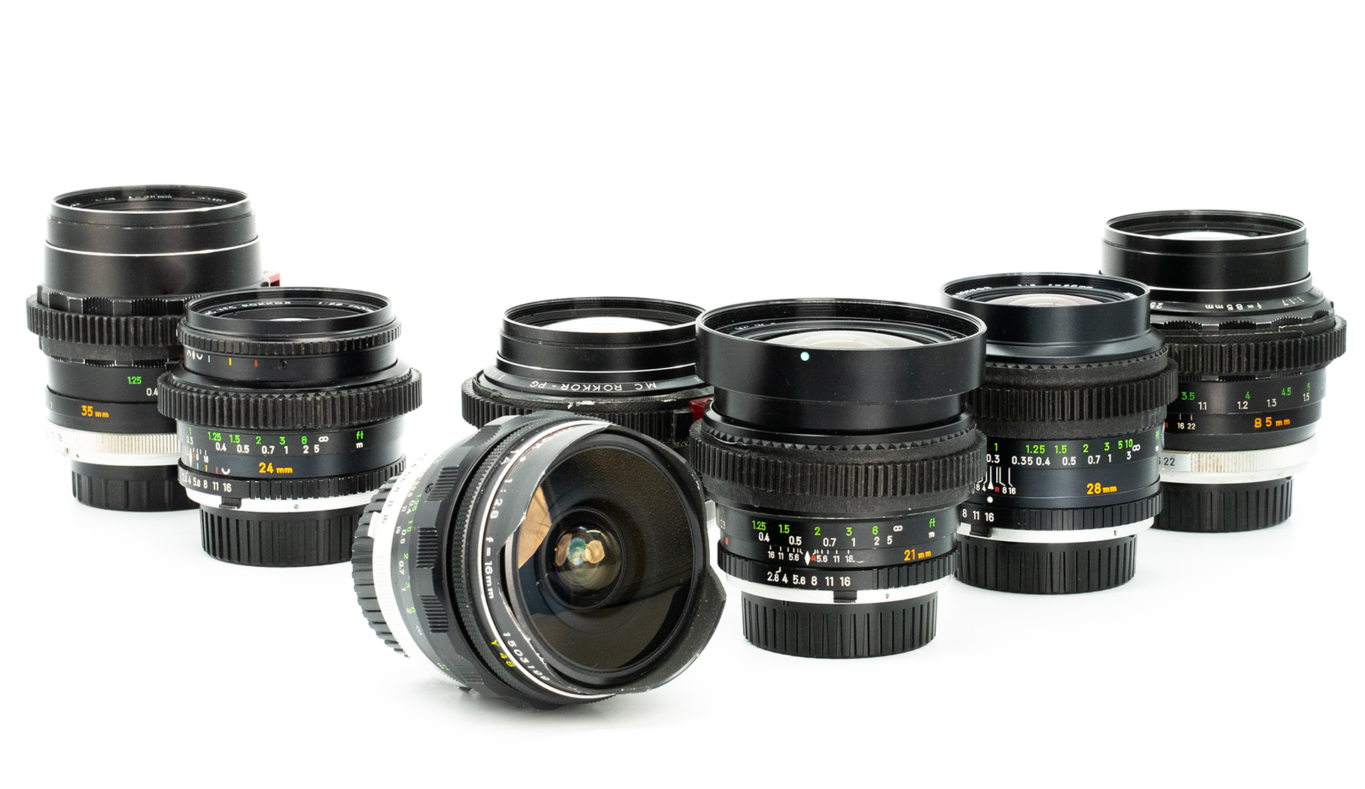 Full set of Minolta Rokkor mirrorless cine lenses displayed on a white background, including 16mm 21mm, 24mm, 28mm, 35mm and 58mm and 85mm focal lengths with E-mount capability.
