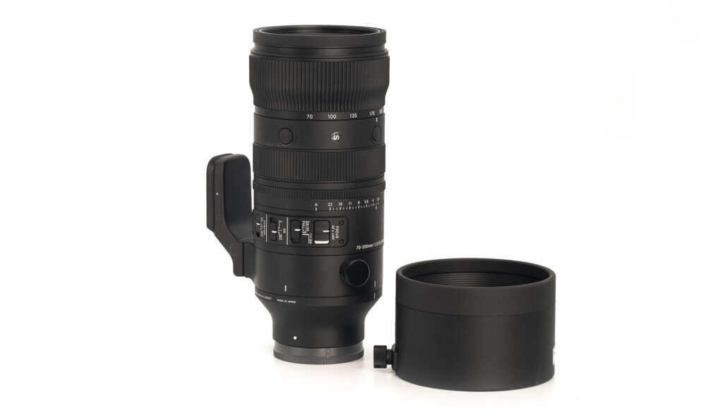 Camera lens with detachable hood